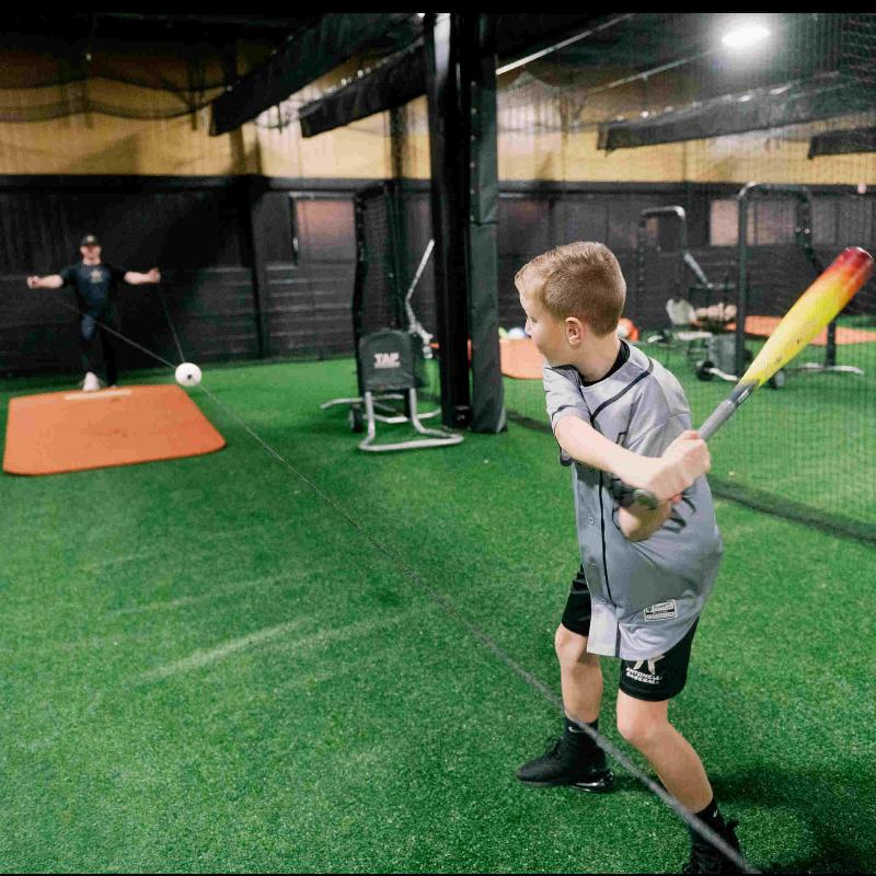 A young boy practices with a Rope Ripper in an indoor facility.