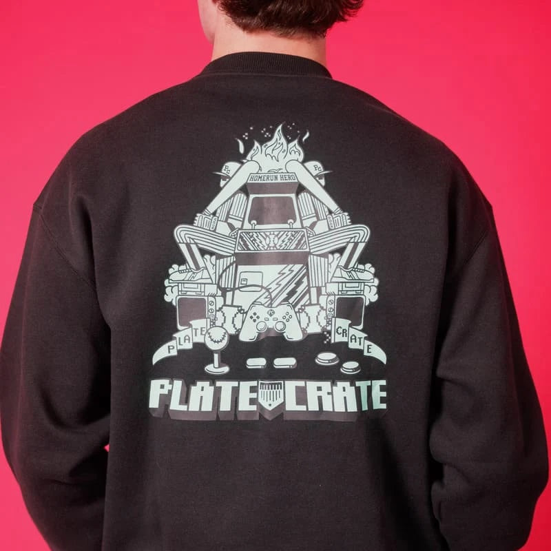 Back view of a teenage boy wearing Plate Crate's Retro Gamer Crewneck.