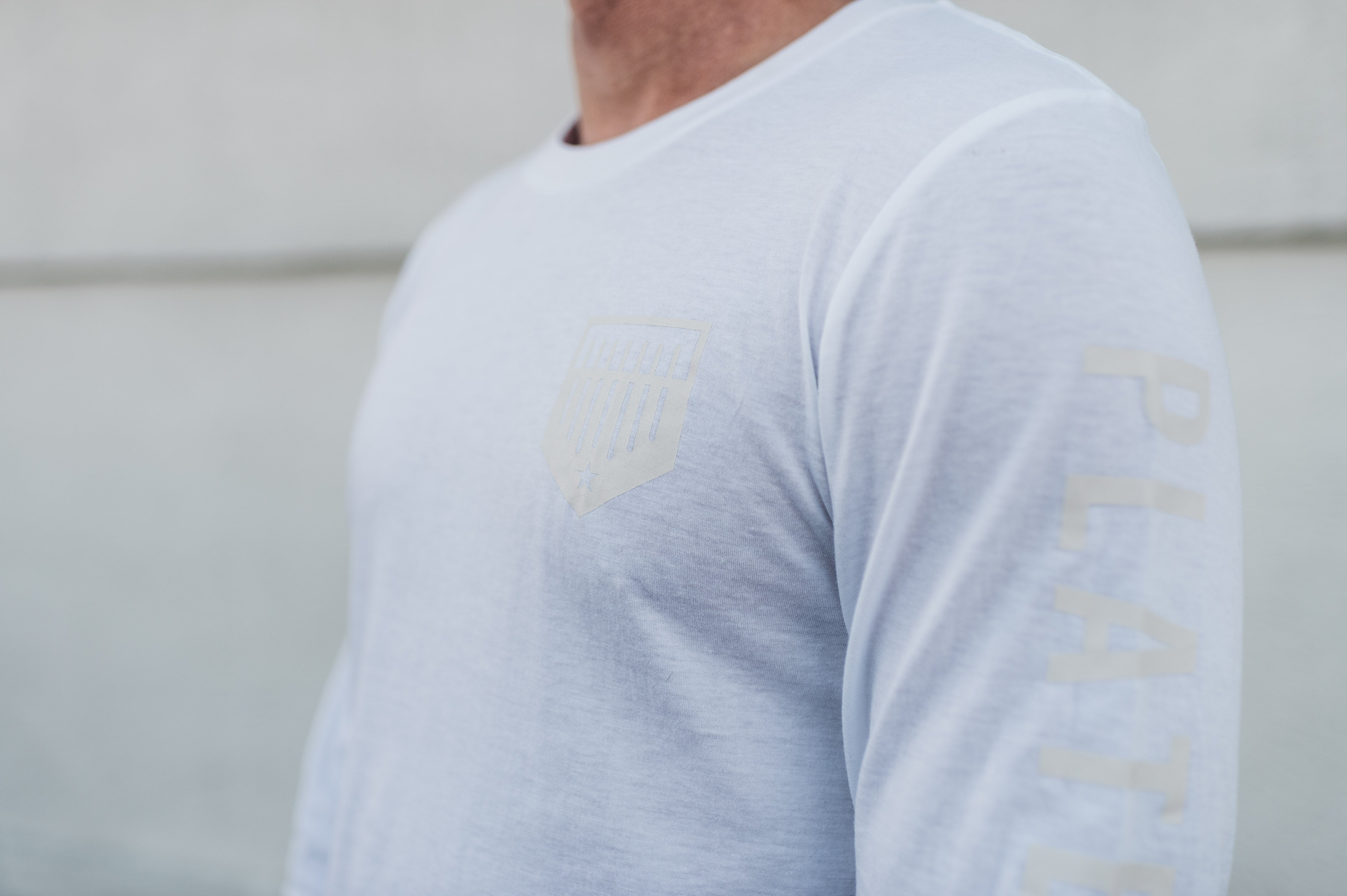 Closeup of Plate Crate logos on Pearl Long Sleeve